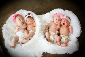 four-babies-with-bows-in-baskets